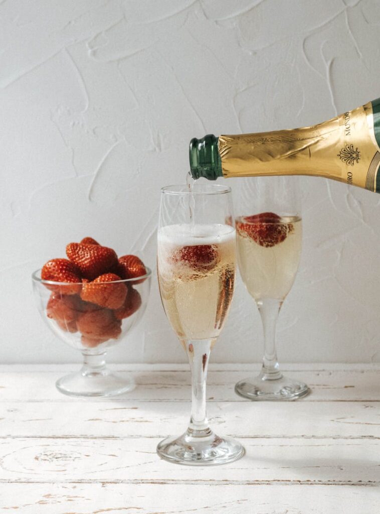 Elegant champagne glass filled as strawberries rest alluringly within, creating a festive atmosphere.