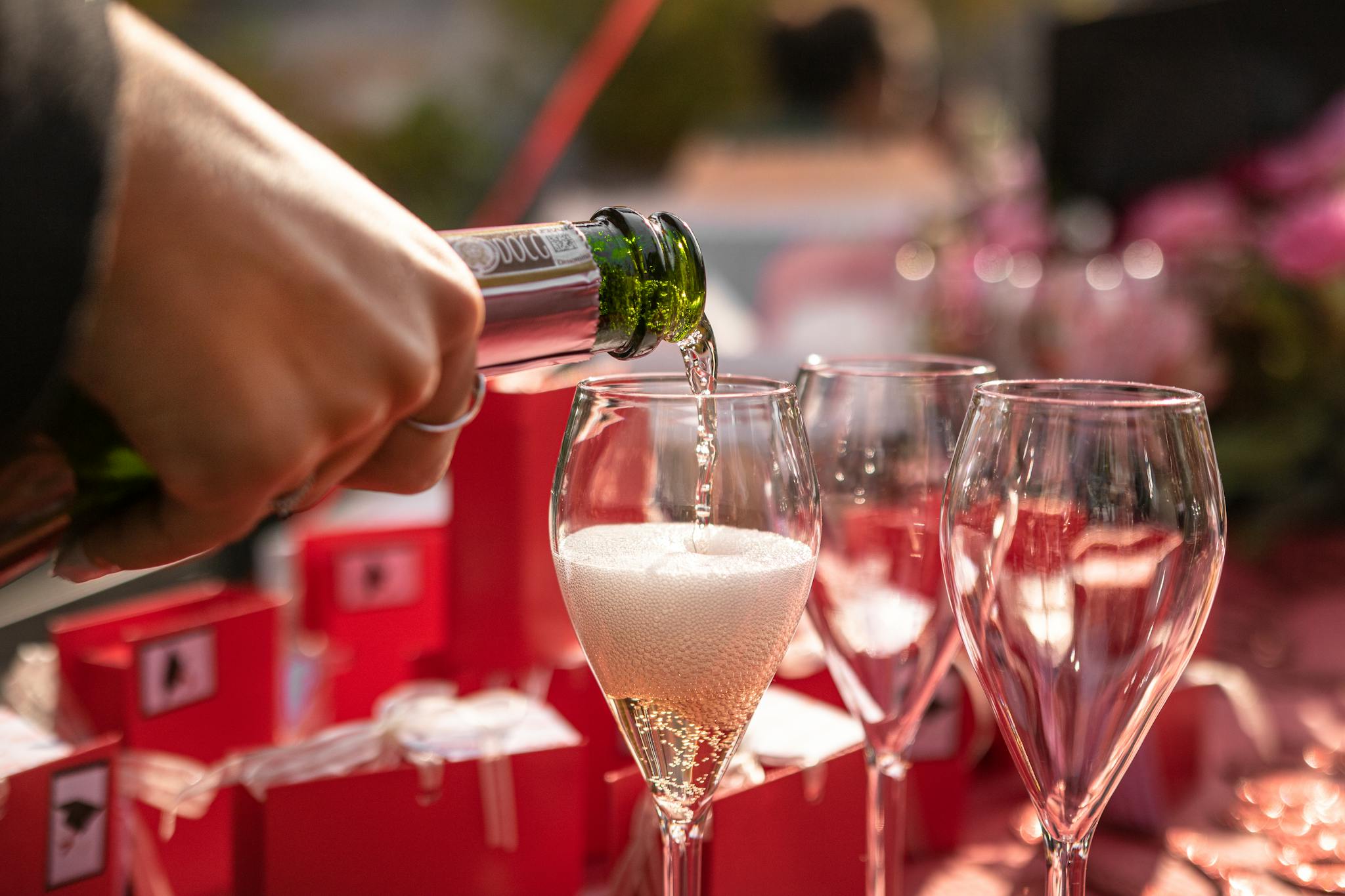 A festive scene of champagne being poured into glasses at a celebration in Milano, Italy.